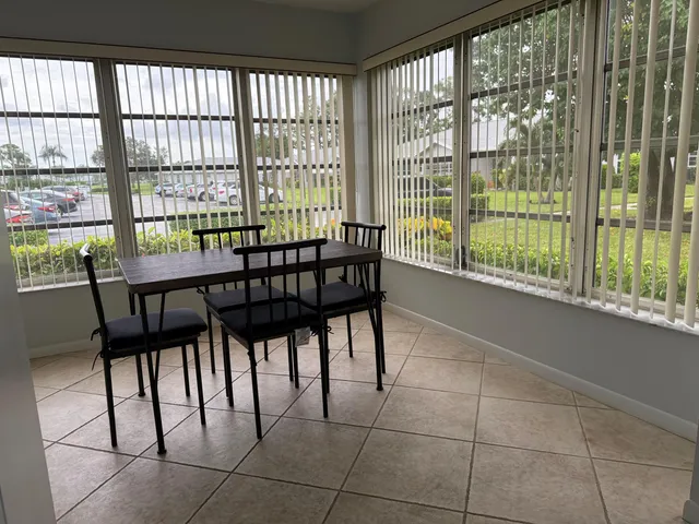 a view of a dining room with furniture and a window