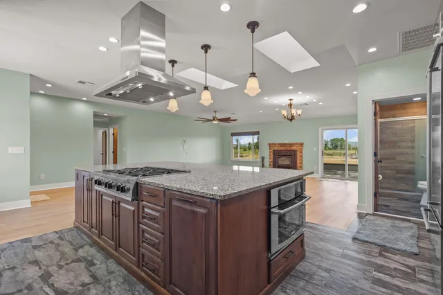 an open kitchen with a stove and a sink