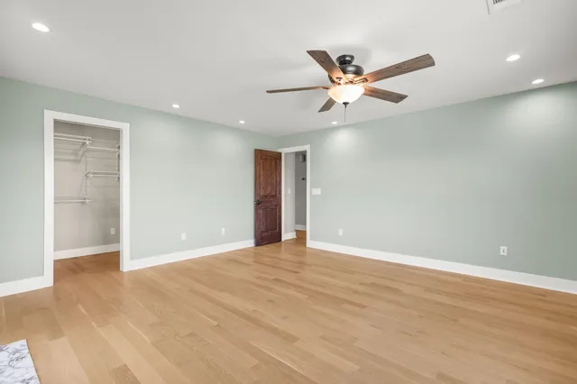 a view of an empty room with a ceiling fan