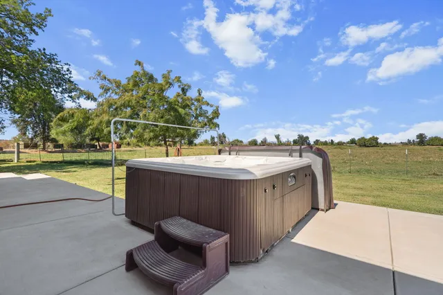 a view of a swimming pool with an outdoor seating and a garden