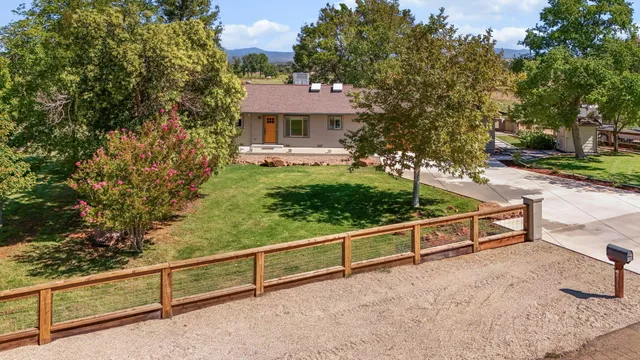 a view of a house with yard and sitting area