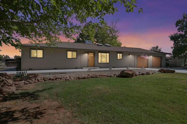 a front view of a house with a garden