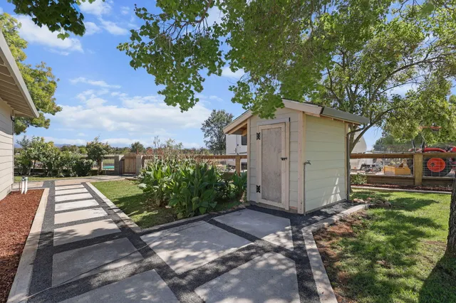 a view of a garden with wooden fence