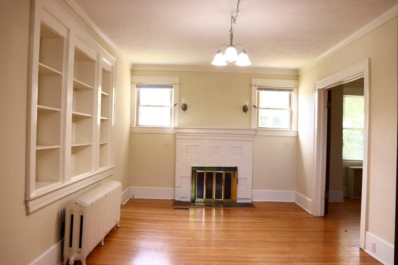 7760 Williamson Road Roanoke, VA 24019 - Photo 11 of 16 a view of an empty room with wooden floor and a window