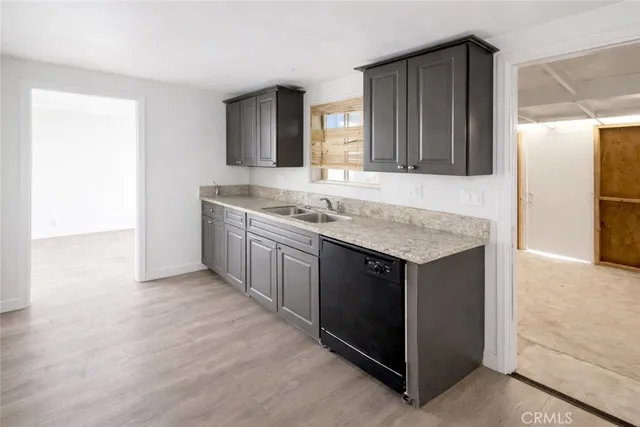 a kitchen with a sink and a refrigerator