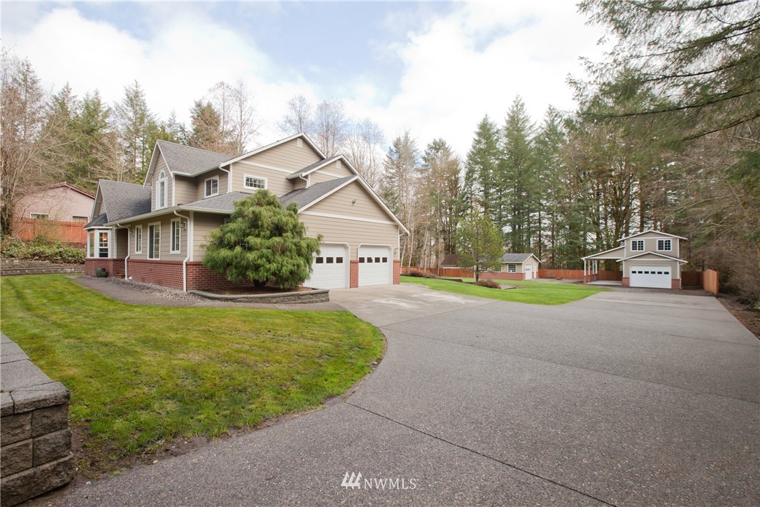 7736 Fairview Road Southwest Tumwater, WA 98512 - Photo 2 of 25 a front view of house with yard and green space