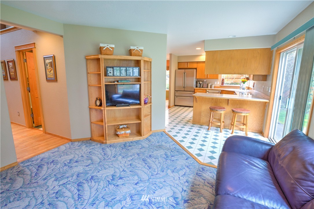 7736 Fairview Road Southwest Tumwater, WA 98512 - Photo 11 of 25 a living room with furniture and a large window