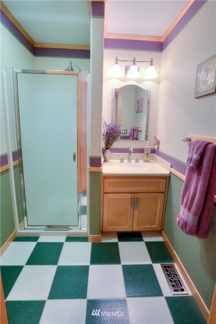 7736 Fairview Road Southwest Tumwater, WA 98512 - Photo 12 of 25 a room with a black white checkered floor with a black and white checkered floor