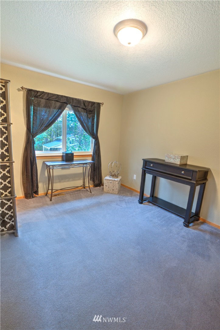 7736 Fairview Road Southwest Tumwater, WA 98512 - Photo 19 of 25 an empty room with furniture and a window