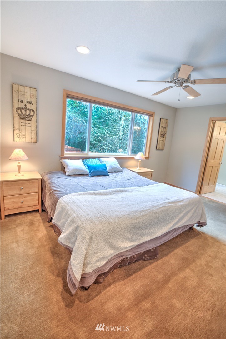 7736 Fairview Road Southwest Tumwater, WA 98512 - Photo 21 of 25 a bedroom with a bed and a large window