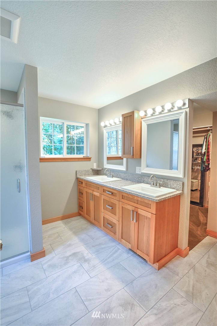 7736 Fairview Road Southwest Tumwater, WA 98512 - Photo 22 of 25 a large bathroom with a large tub and sink