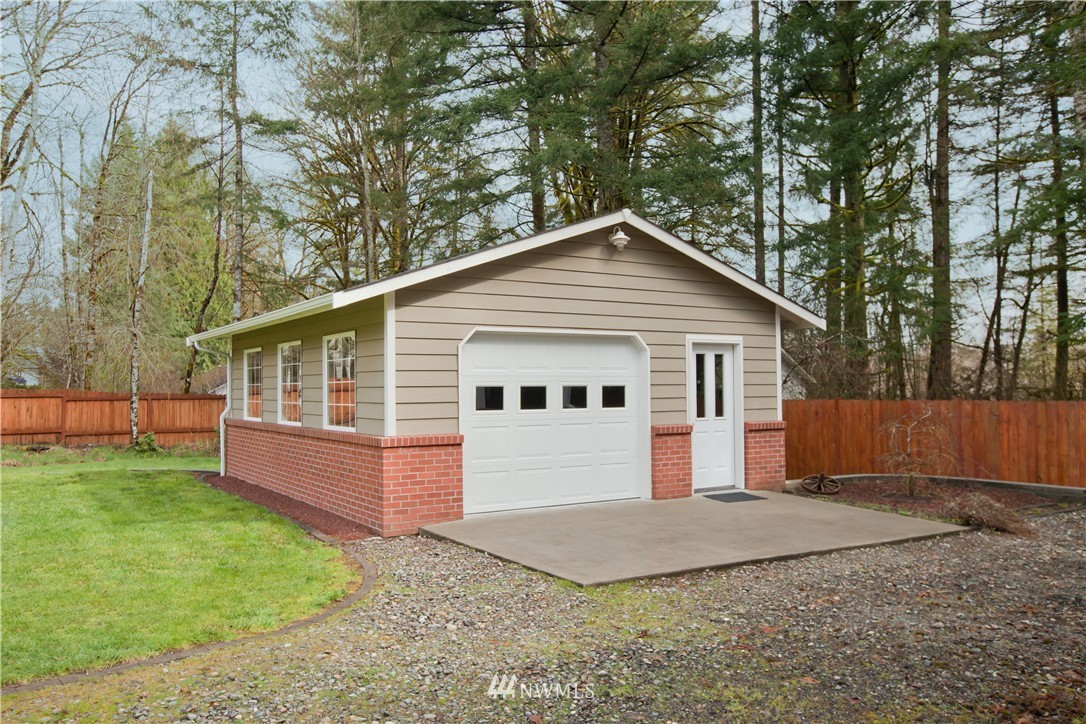 7736 Fairview Road Southwest Tumwater, WA 98512 - Photo 24 of 25 a front view of a house with a yard and garage
