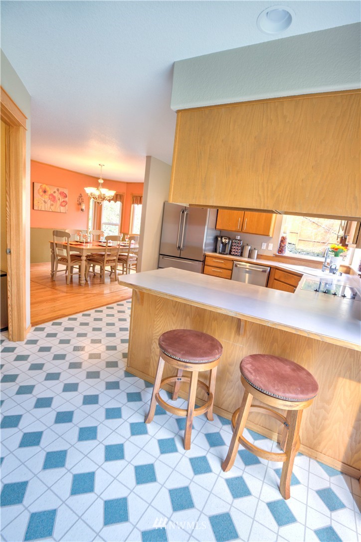 7736 Fairview Road Southwest Tumwater, WA 98512 - Photo 9 of 25 a dining room with a table and chairs next to a large window