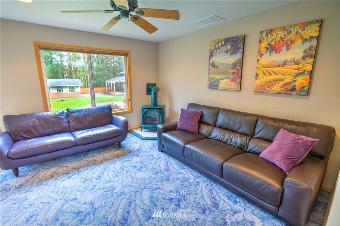 7736 Fairview Road Southwest Tumwater, WA 98512 - Photo 10 of 25 a living room with furniture and a large window