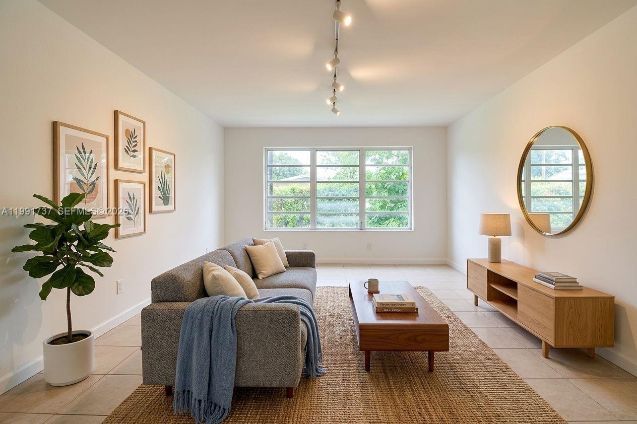 8285 Southwest 104th Street Miami, FL 33156 - Photo 11 of 21 a living room with furniture and a large window