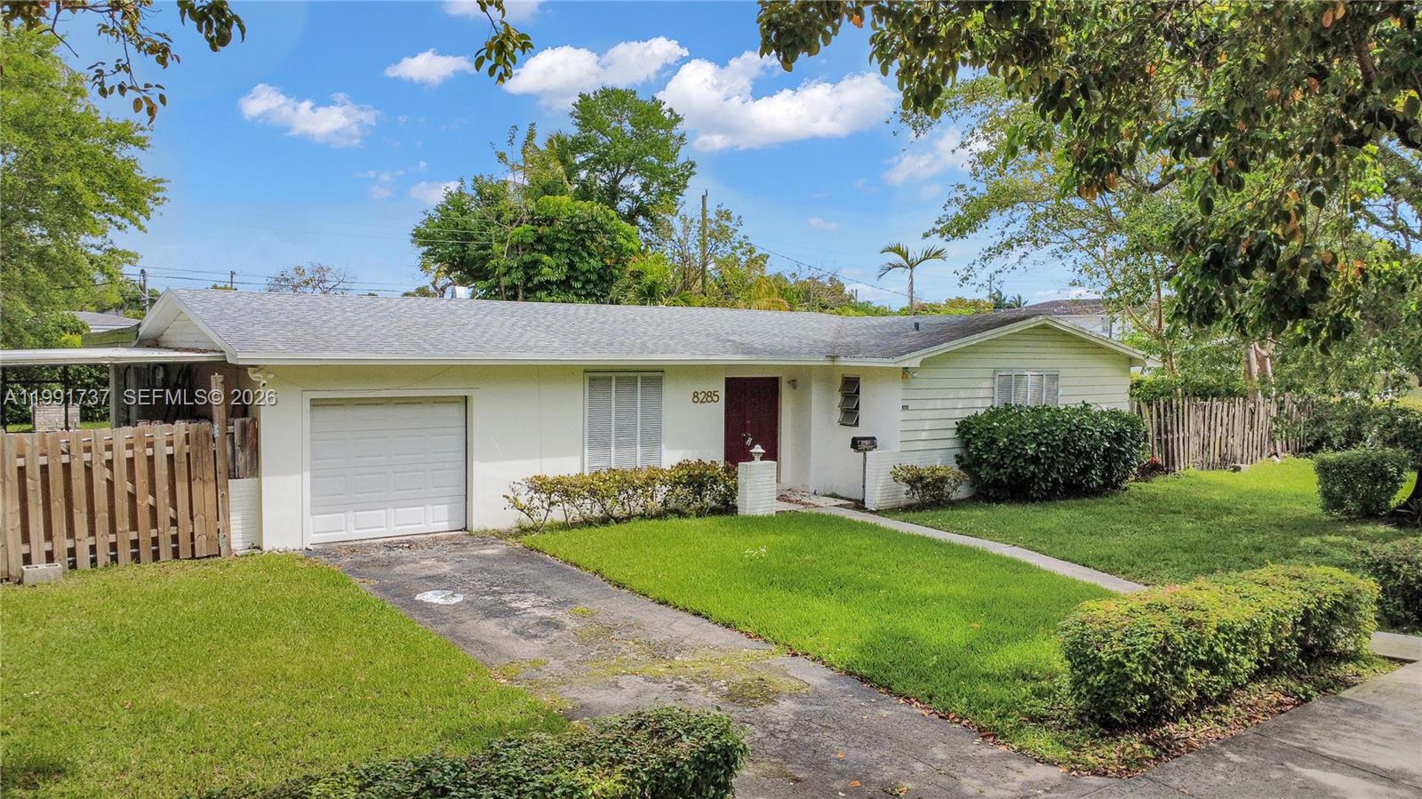 8285 Southwest 104th Street Miami, FL 33156 - Photo 13 of 21 a front view of a house with a yard and porch