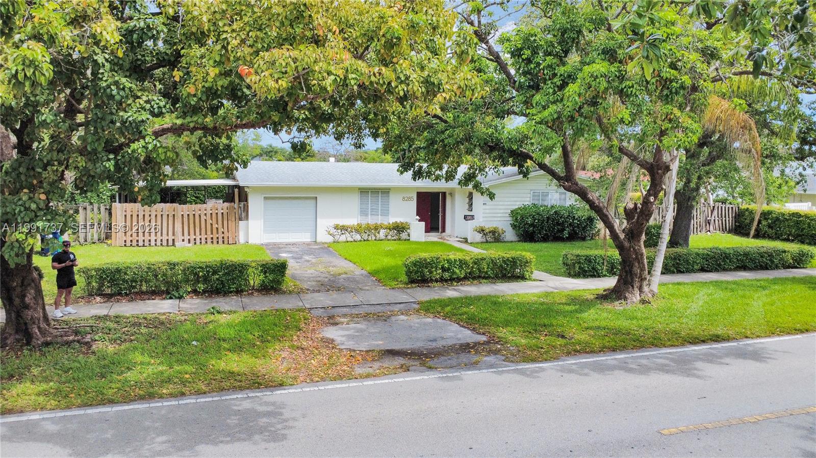 8285 Southwest 104th Street Miami, FL 33156 - Photo 14 of 21 a front view of a house with a garden