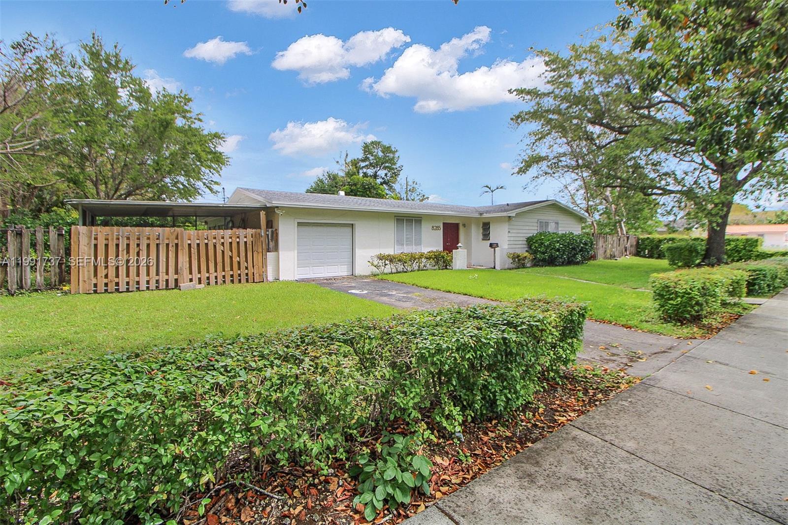 8285 Southwest 104th Street Miami, FL 33156 - Photo 15 of 21 a front view of a house with garden