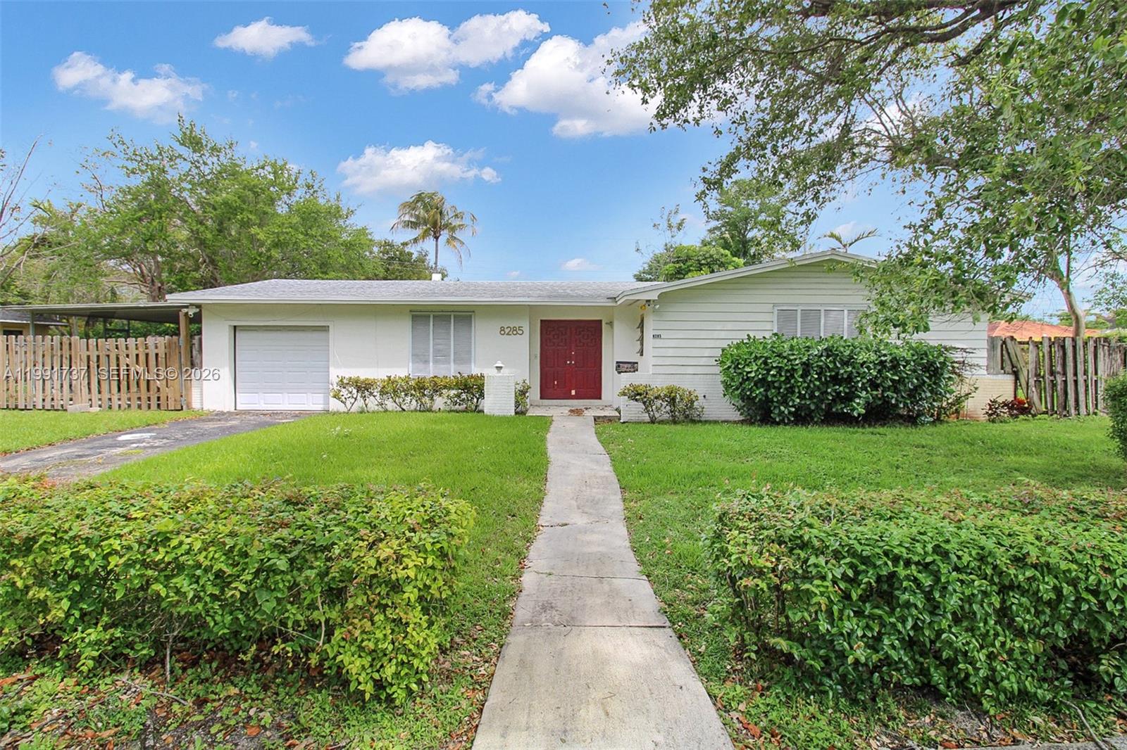 8285 Southwest 104th Street Miami, FL 33156 - Photo 16 of 21 a front view of house with yard and green space