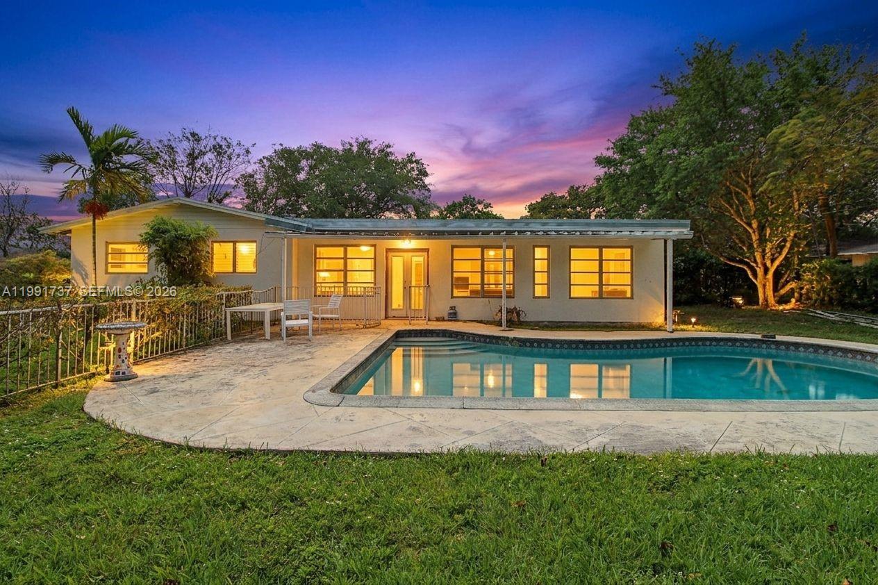 8285 Southwest 104th Street Miami, FL 33156 - Photo 3 of 21 a front view of a house with a yard