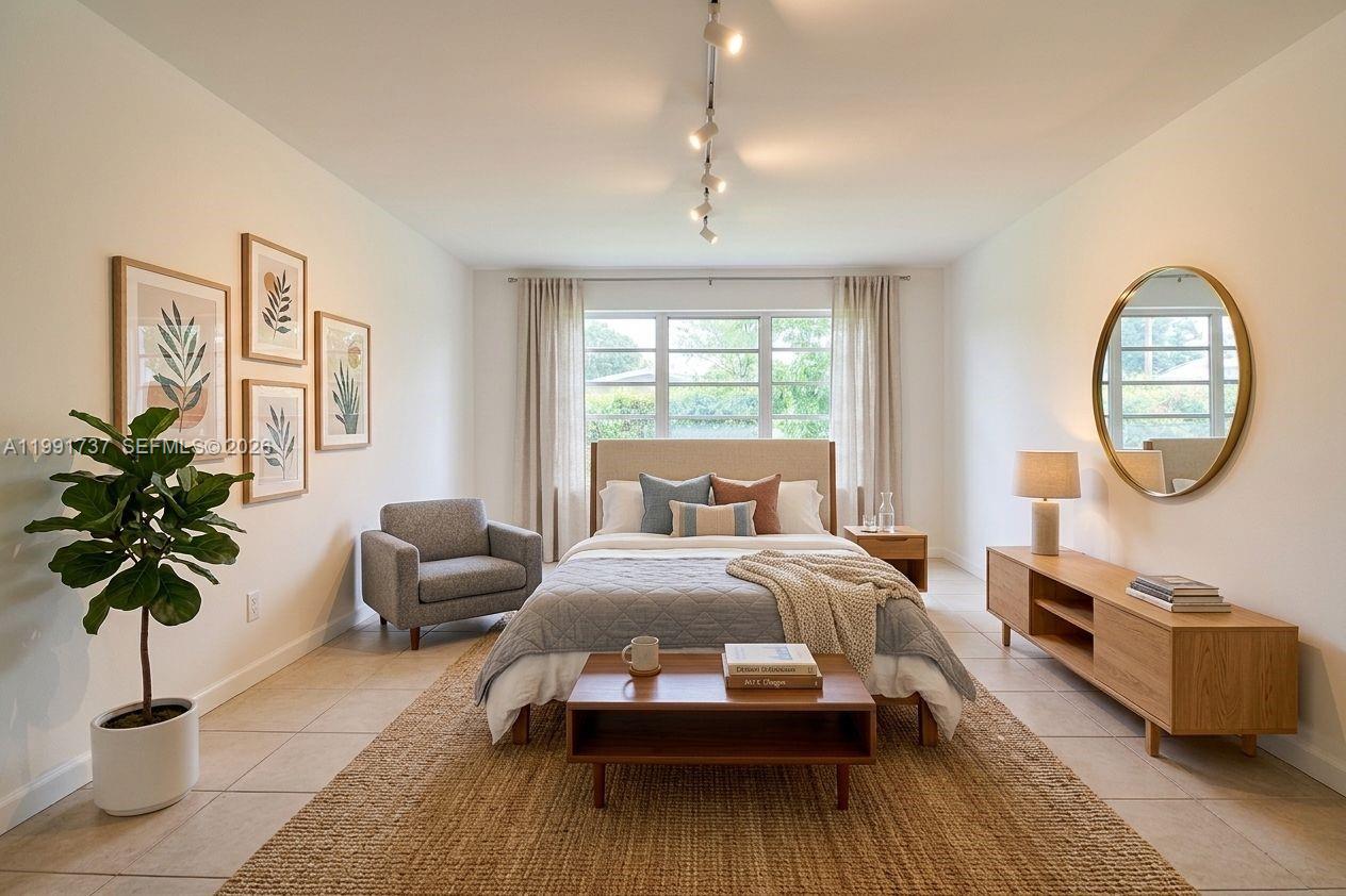 8285 Southwest 104th Street Miami, FL 33156 - Photo 4 of 21 a bedroom with furniture and a large window