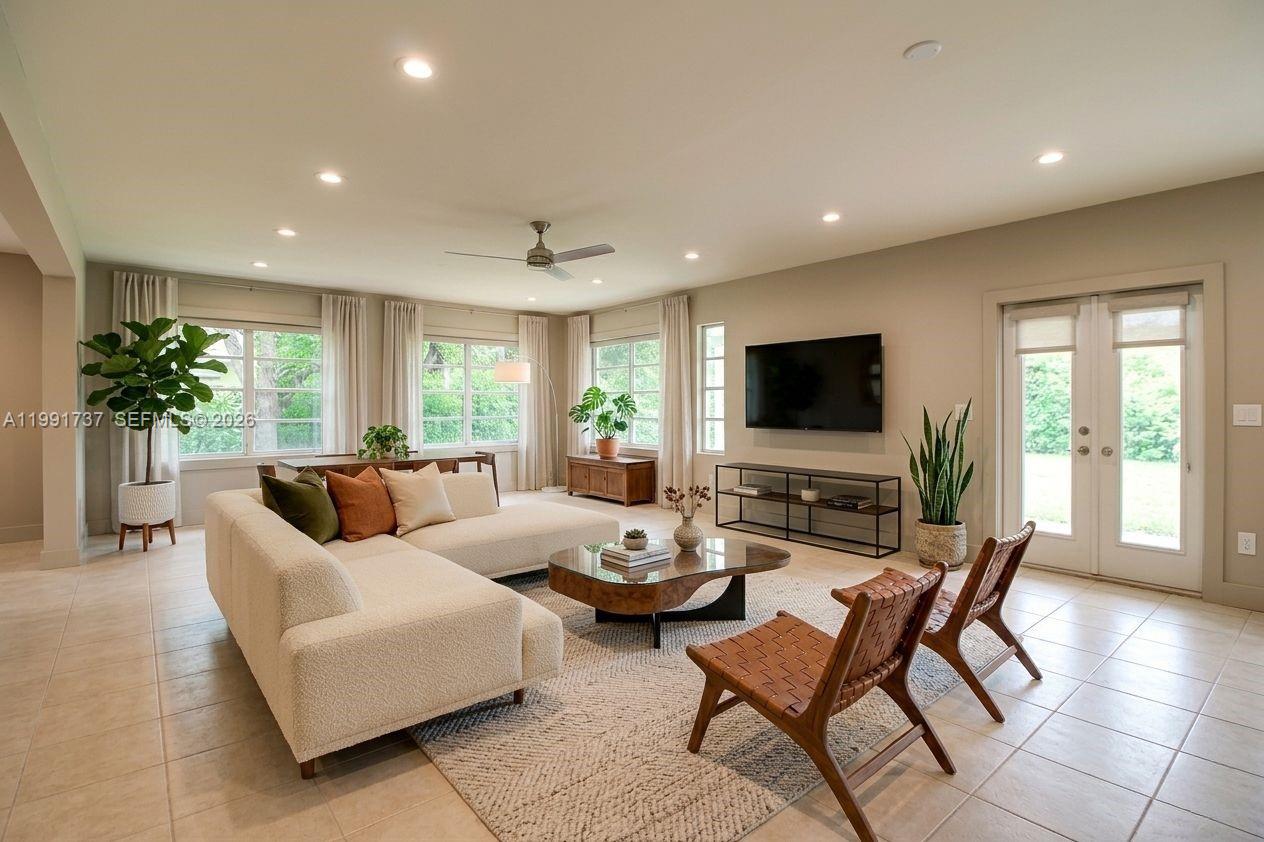 8285 Southwest 104th Street Miami, FL 33156 - Photo 6 of 21 a living room with furniture and a flat screen tv