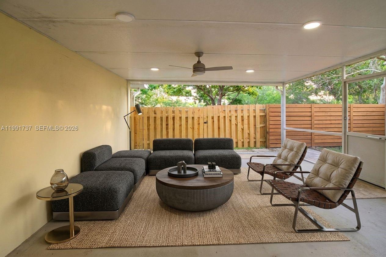 8285 Southwest 104th Street Miami, FL 33156 - Photo 8 of 21 a living room with furniture and a large window