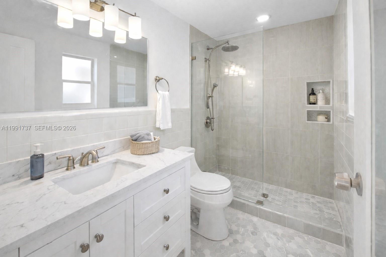 8285 Southwest 104th Street Miami, FL 33156 - Photo 9 of 21 a bathroom with a sink a toilet and shower