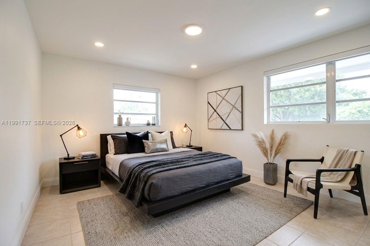 8285 Southwest 104th Street Miami, FL 33156 - Photo 10 of 21 a bedroom with a bed and a window