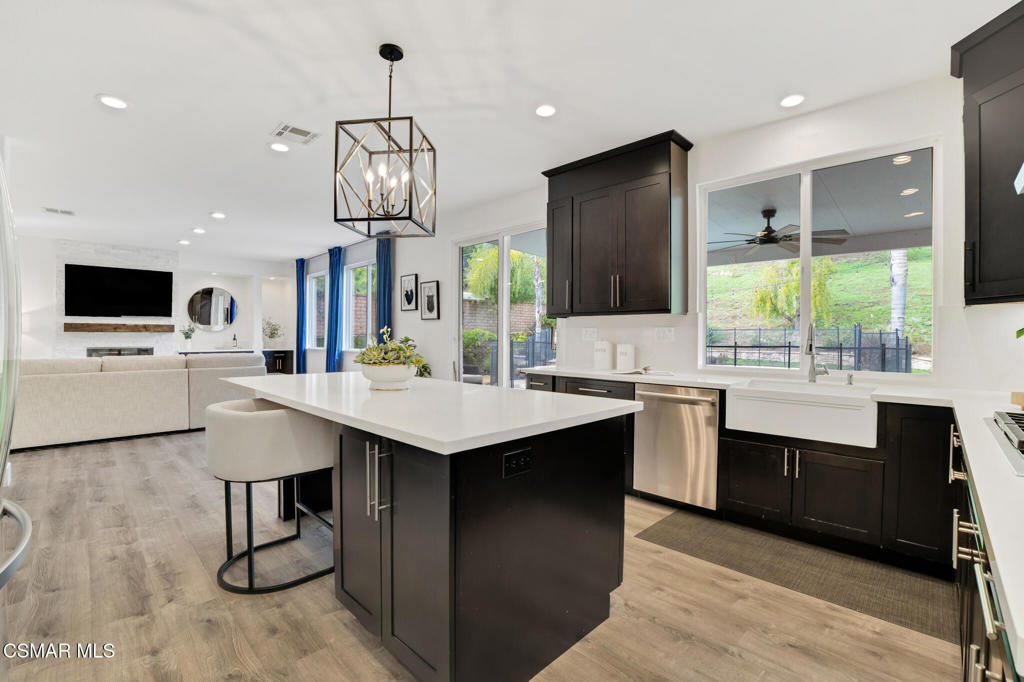 2339 Rudolph Drive Simi Valley, CA 93065 - Photo 12 of 60 a kitchen with stainless steel appliances kitchen island a large island in the center and sink