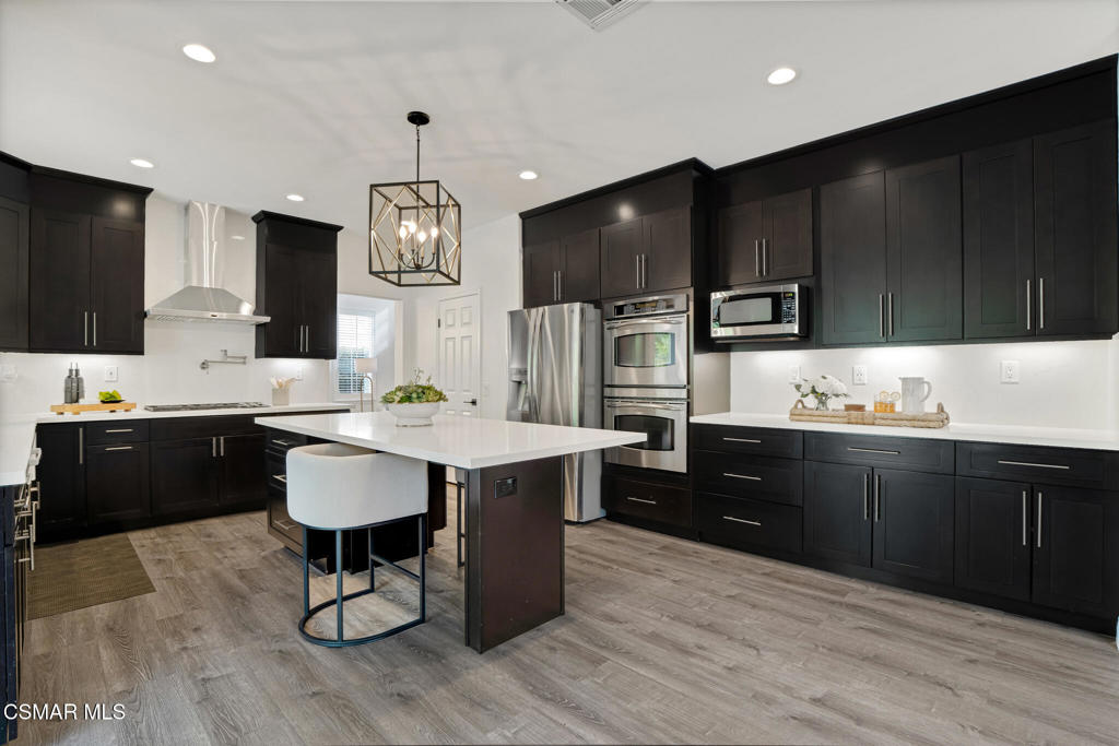 2339 Rudolph Drive Simi Valley, CA 93065 - Photo 14 of 60 a kitchen with granite countertop a sink appliances and cabinets