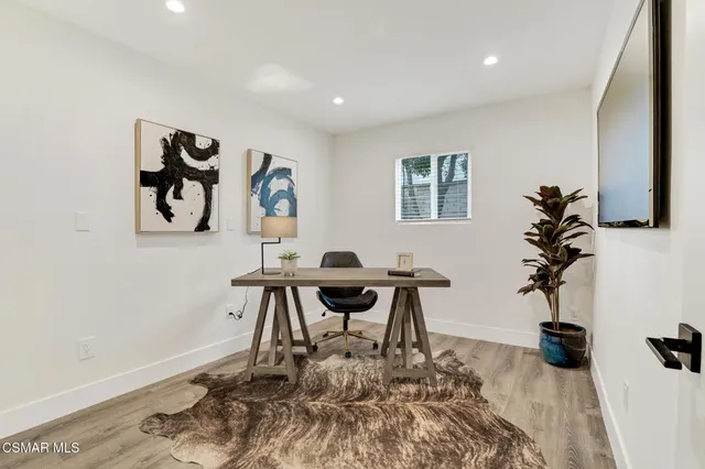a spacious bedroom with a bed and a window