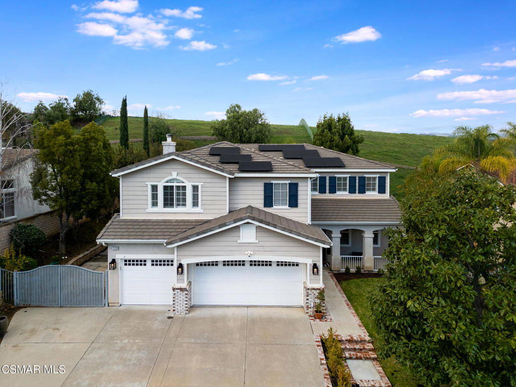 2339 Rudolph Drive Simi Valley, CA 93065 - Photo 2 of 60 a view of a white house next to a yard with potted plants and large trees