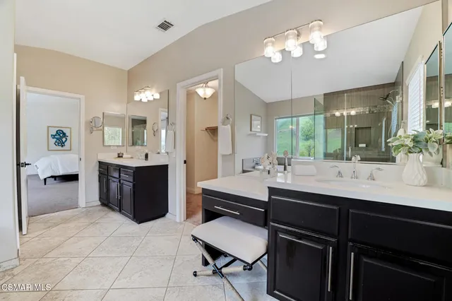 a bathroom with double vanity sink and mirror