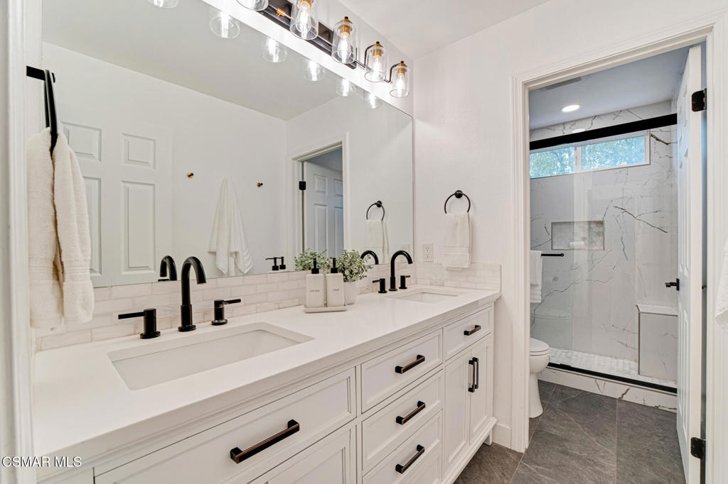 2339 Rudolph Drive Simi Valley, CA 93065 - Photo 29 of 60 a bathroom with double vanity sink and mirror