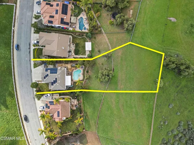 a view of a hallway with wooden floor and furniture