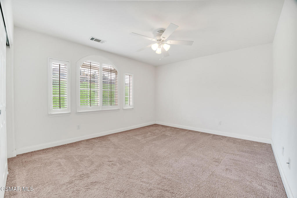 2339 Rudolph Drive Simi Valley, CA 93065 - Photo 32 of 60 an empty room with windows and chandelier fan