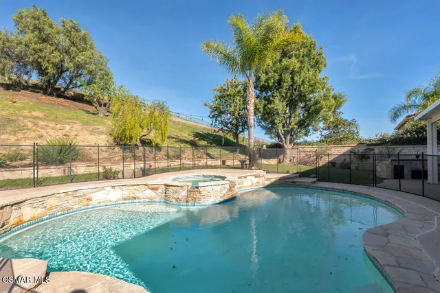 a swimming pool with outdoor seating and yard