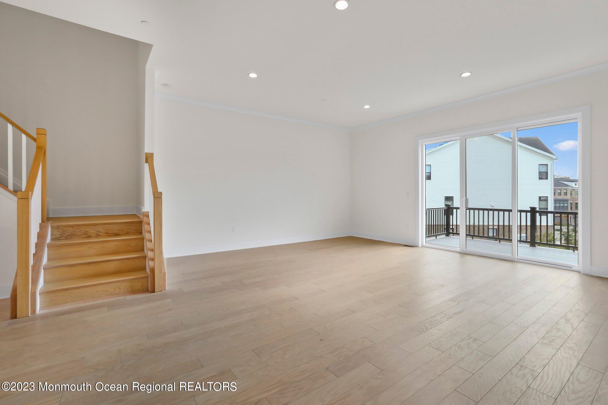 3 Valiant Court Middletown, NJ 07748 - Photo 18 of 42 a view of a hallway with wooden floor and a cabinet