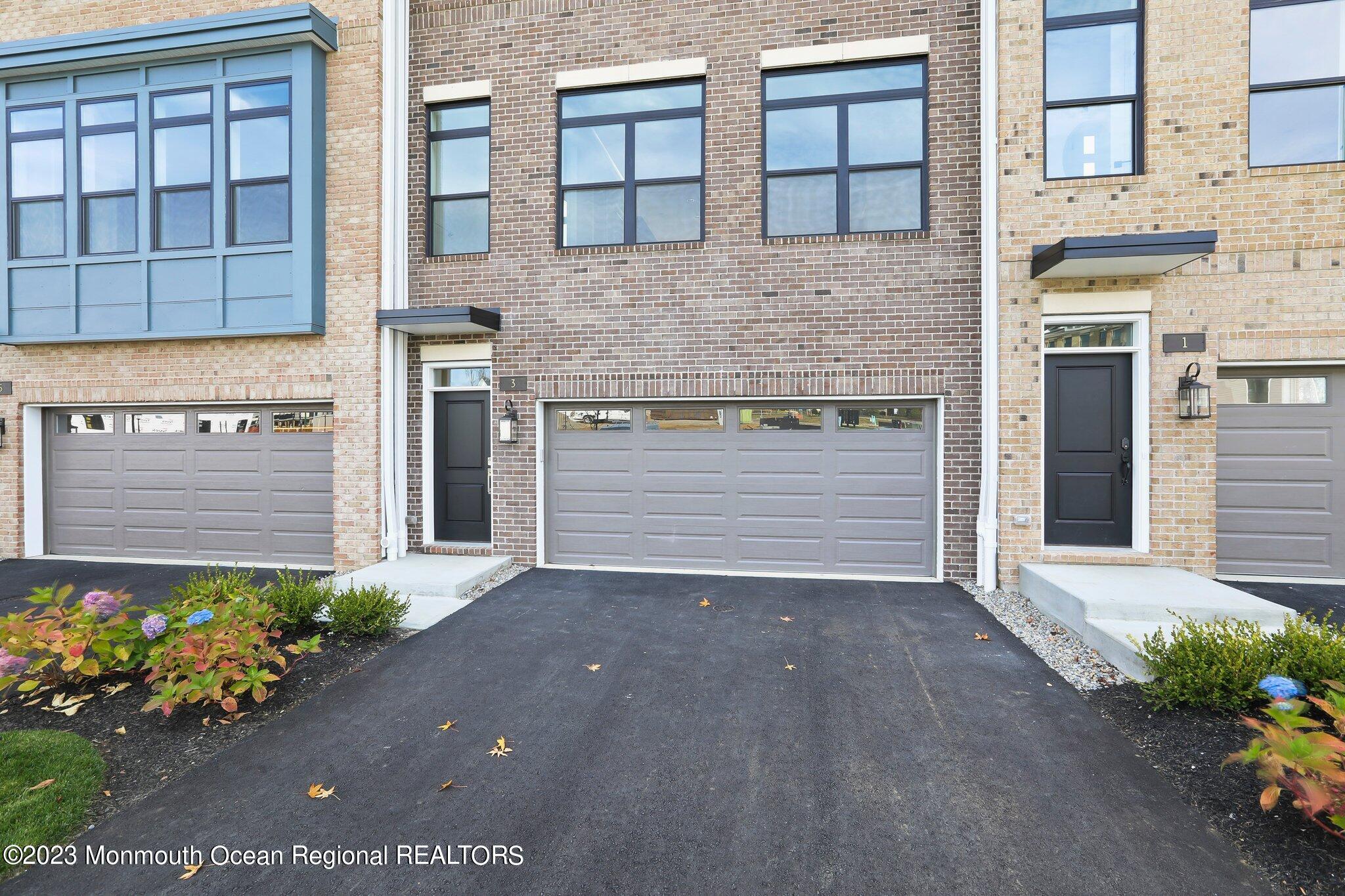 3 Valiant Court Middletown, NJ 07748 - Photo 2 of 42 a front view of a house with a yard and garage