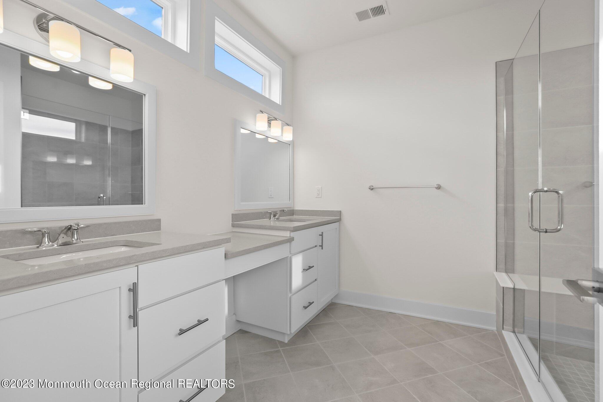 3 Valiant Court Middletown, NJ 07748 - Photo 23 of 42 a spacious bathroom with a granite countertop sink mirror and