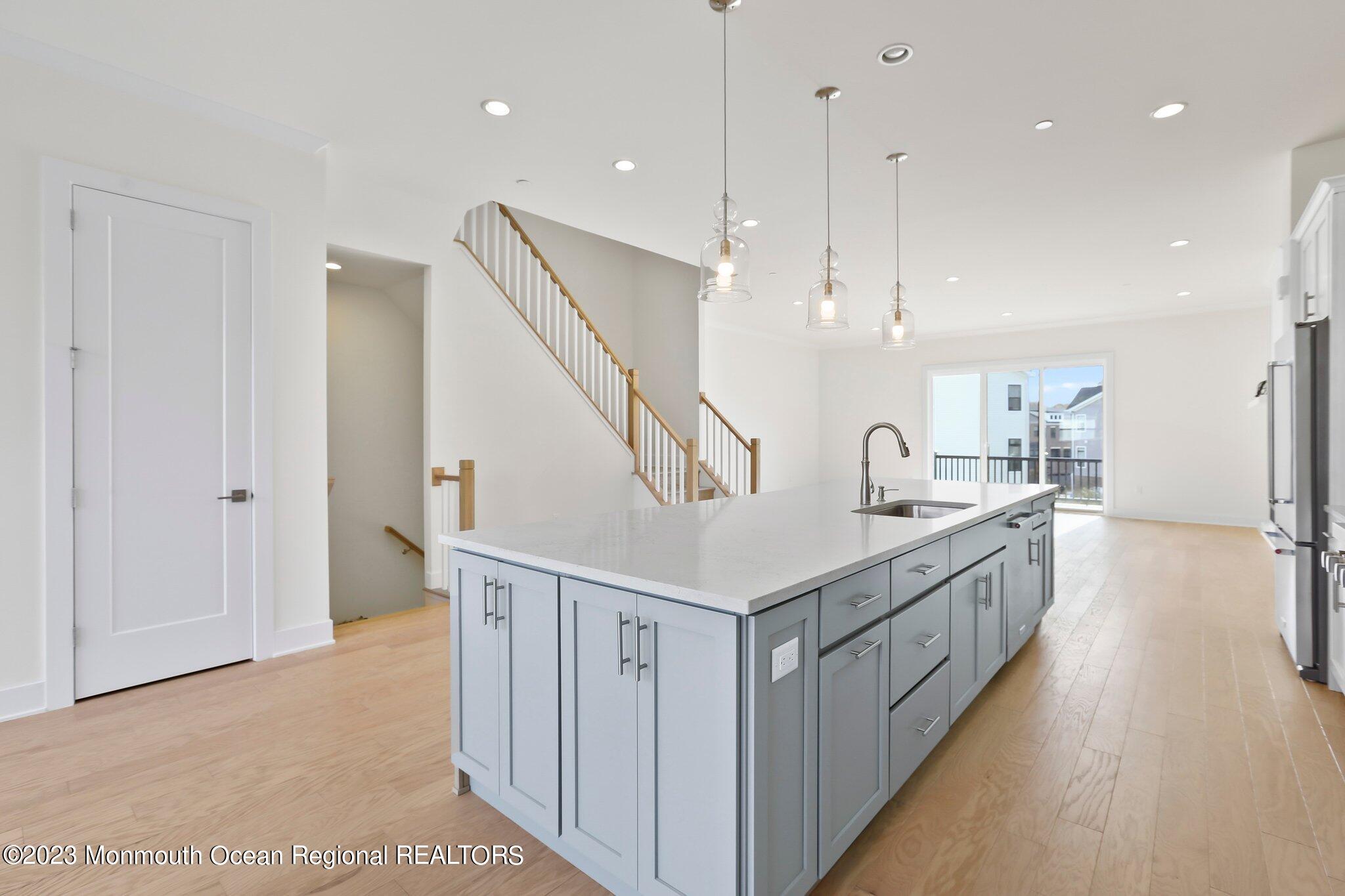 3 Valiant Court Middletown, NJ 07748 - Photo 5 of 42 a large kitchen with stainless steel appliances kitchen island granite countertop a large counter top and a sink