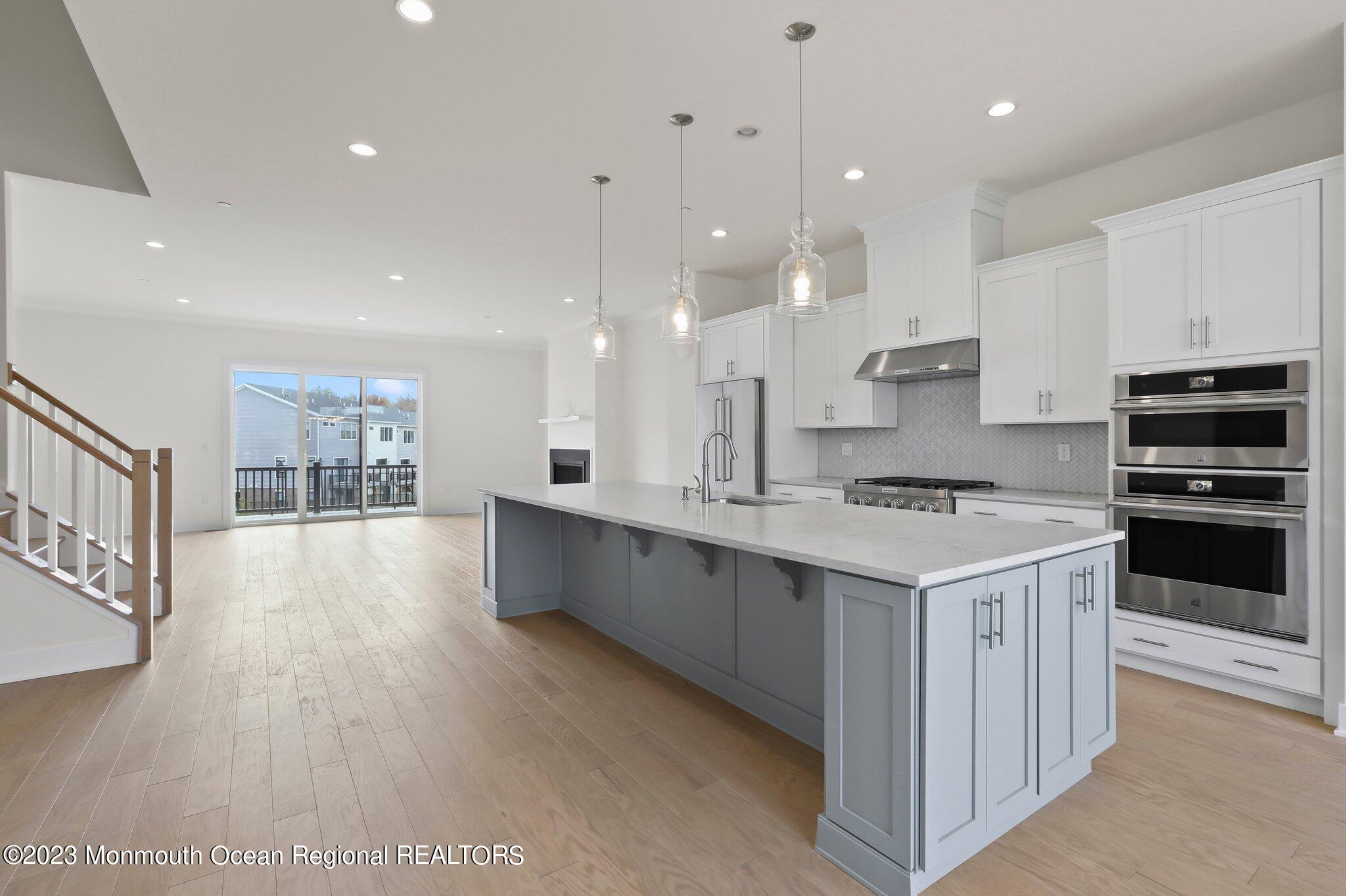 3 Valiant Court Middletown, NJ 07748 - Photo 6 of 42 a large kitchen with kitchen island a sink stainless steel appliances and cabinets