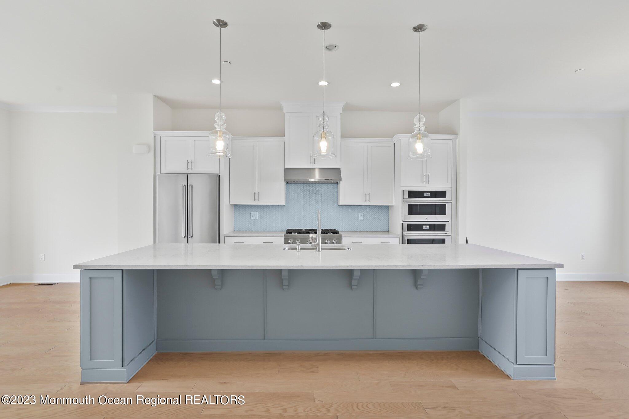 3 Valiant Court Middletown, NJ 07748 - Photo 7 of 42 a large kitchen with kitchen island a sink stainless steel appliances and cabinets