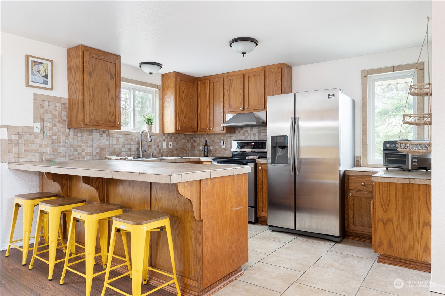 170 Denneboom Road Coupeville, WA 98239 - Photo 16 of 39 a kitchen with stainless steel appliances granite countertop a refrigerator and a stove