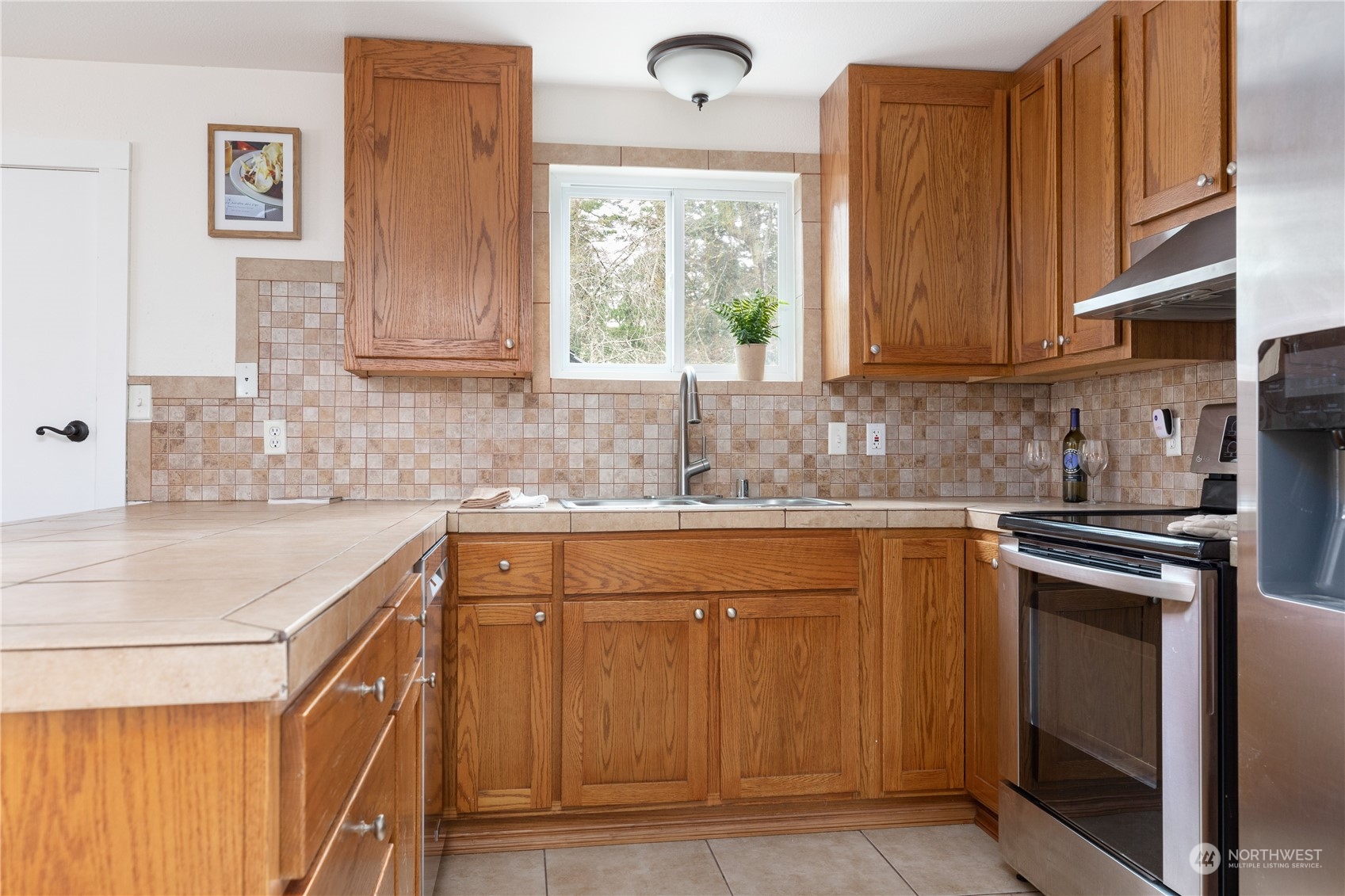 170 Denneboom Road Coupeville, WA 98239 - Photo 17 of 39 a kitchen with stainless steel appliances granite countertop a sink stove and cabinets