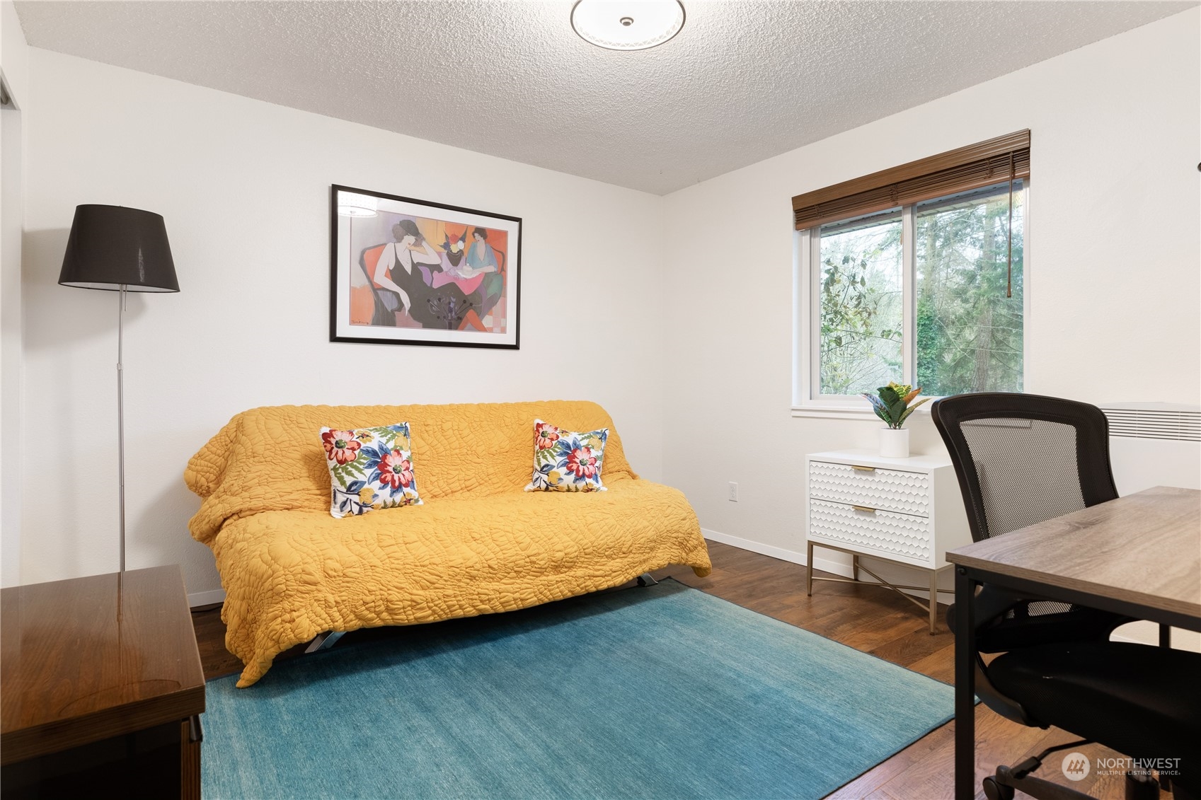 170 Denneboom Road Coupeville, WA 98239 - Photo 27 of 39 a bedroom with a bed a table and a bookshelf