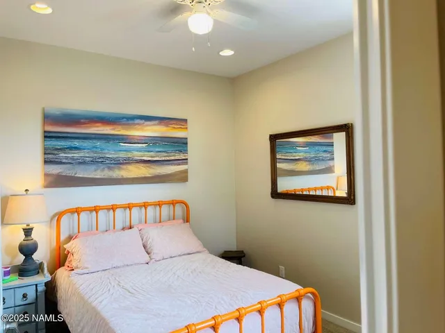 a bedroom with a bed and a painting on the wall