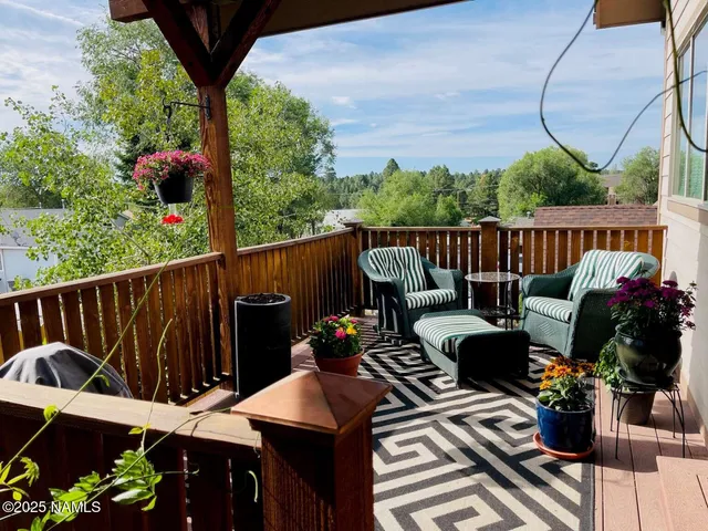 a view of a chairs and table in the roof deck