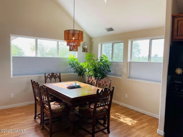 a view of a dining room with furniture and window
